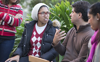 Three students outside talking