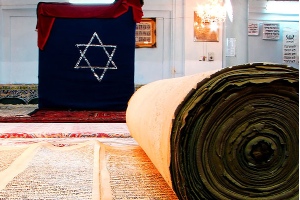 Jewish star and old testament papers rolled up
