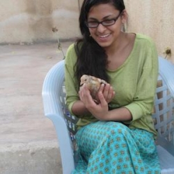 Nora in a chair outside while studying in Jordan